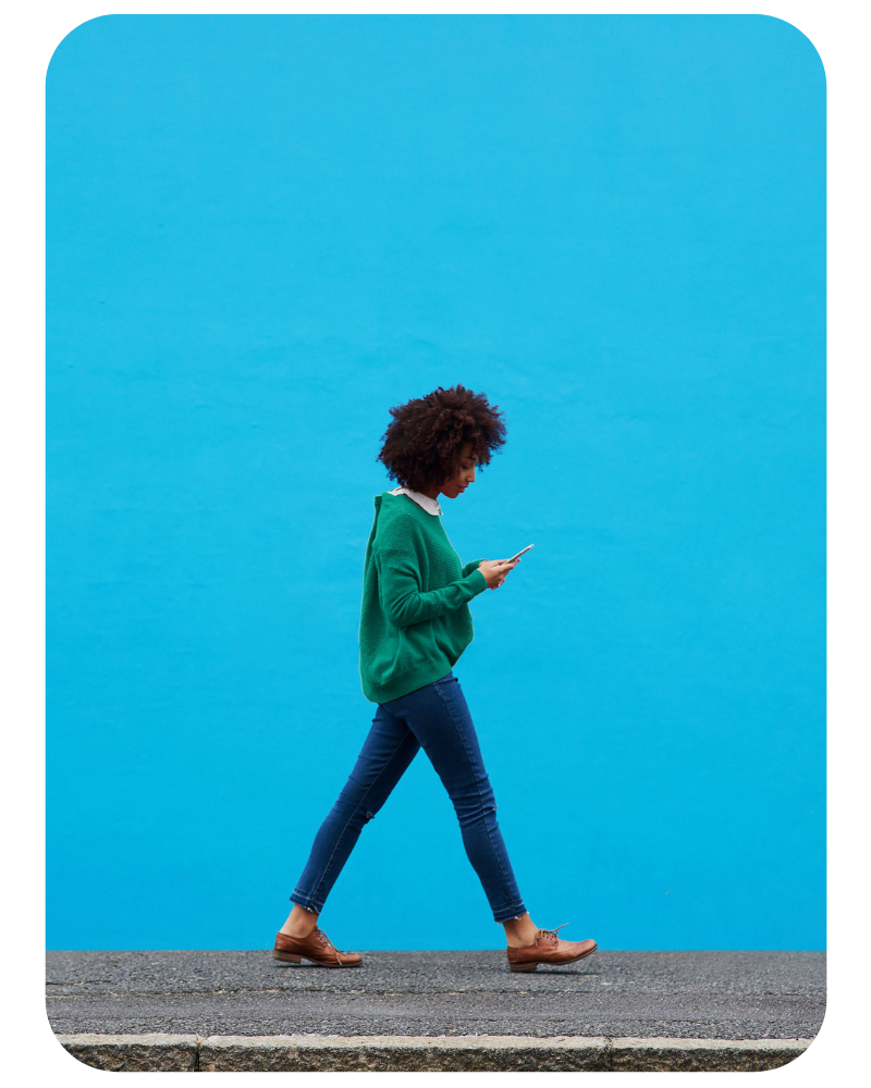 Rounded image of women with phone walking 